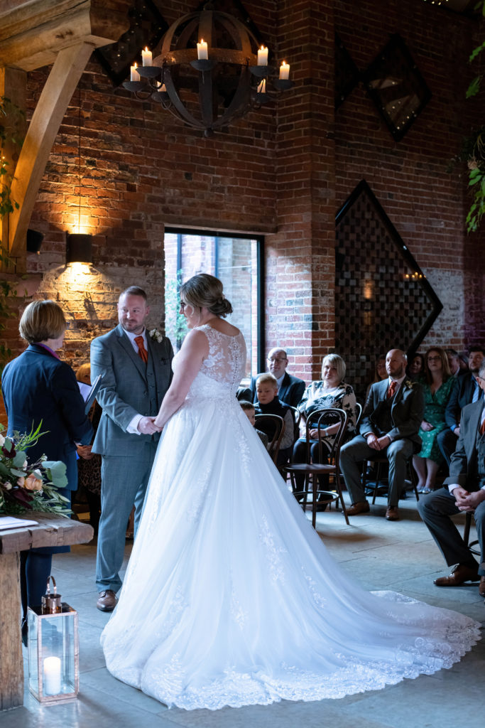 Exchange of vows in the barn’s candlelit ceremony space