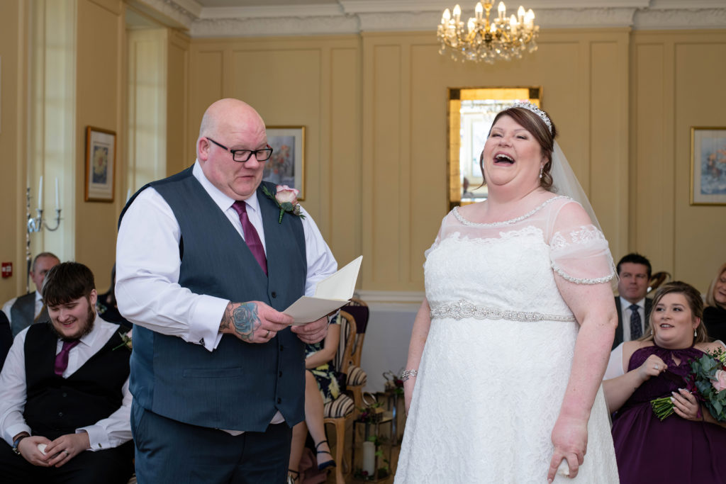 Bride and groom laughing during their celebrant-led Catthorpe Manor wedding