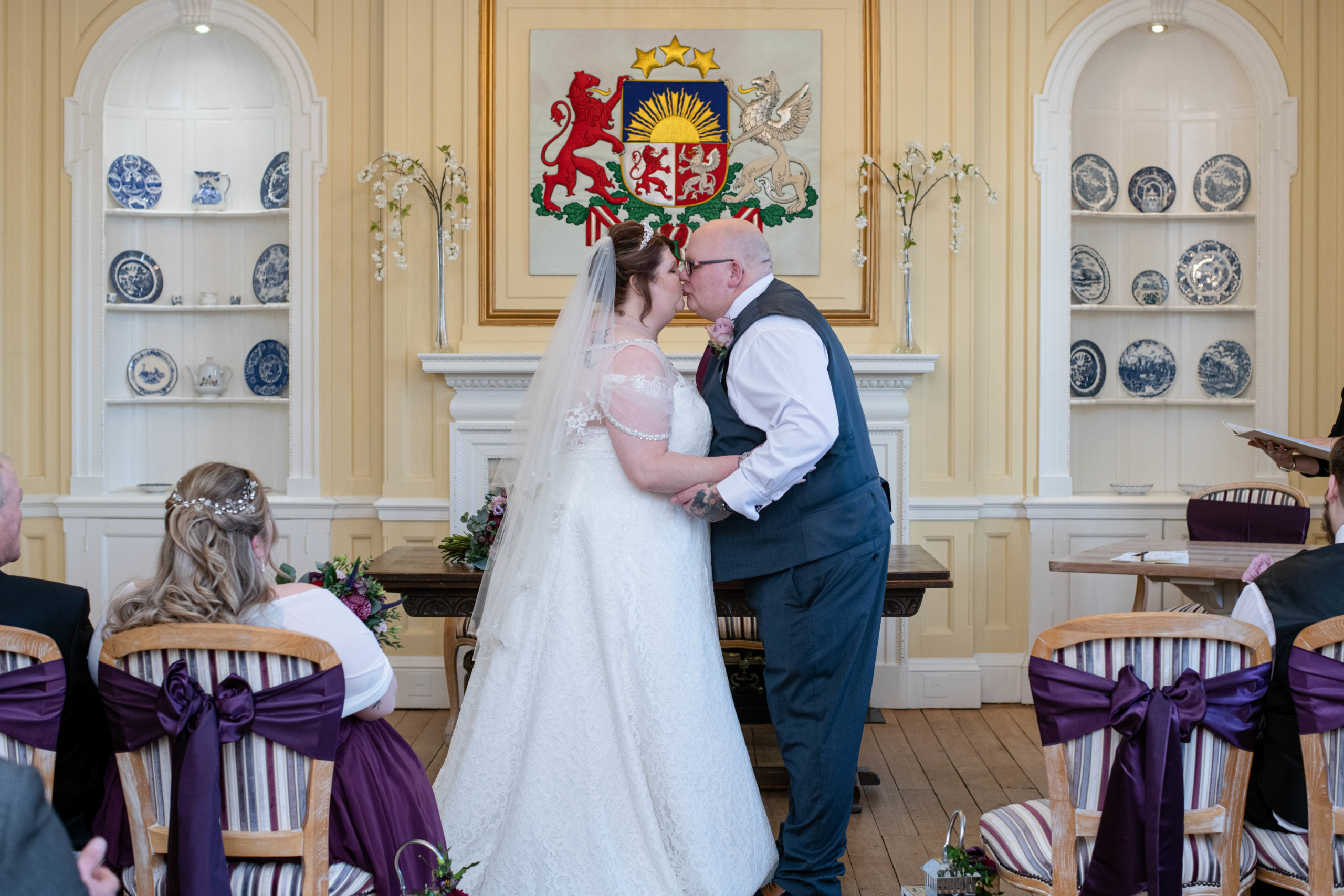 Couple sharing first kiss in Catthorpe Manor ceremony room