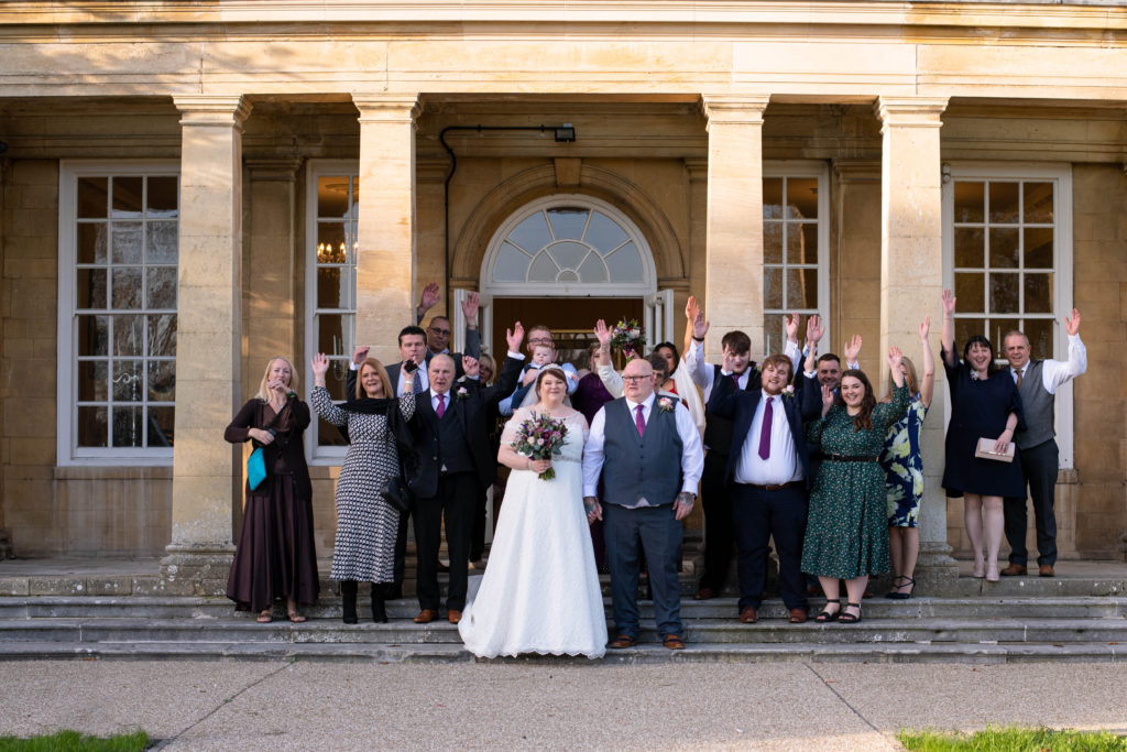 Guests throwing confetti outside Catthorpe Manor