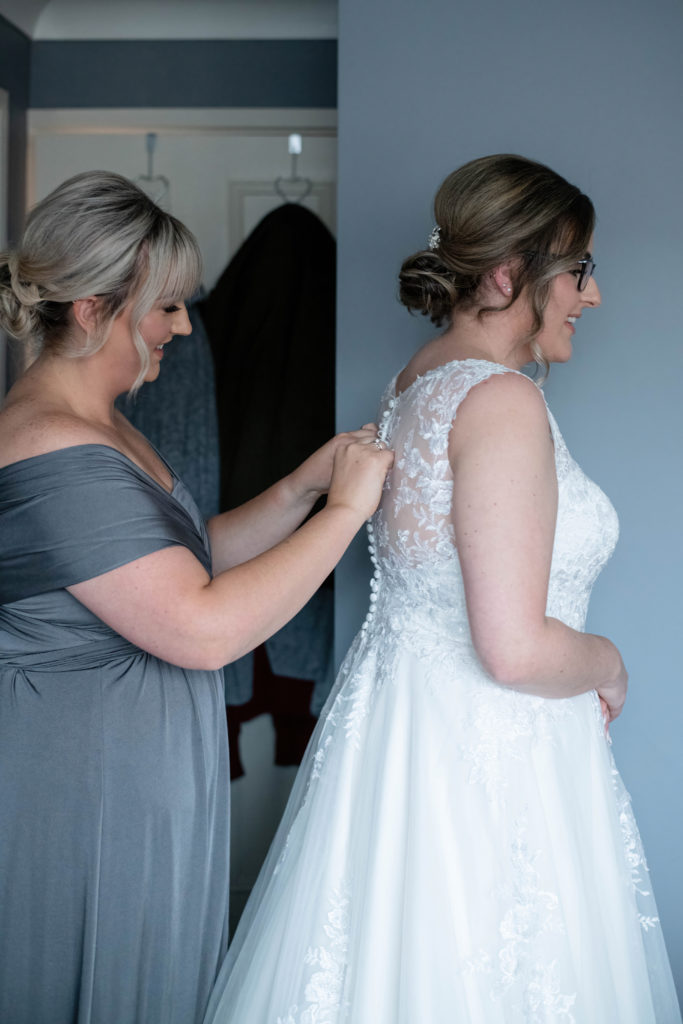 Laura laughing with bridesmaids during prep