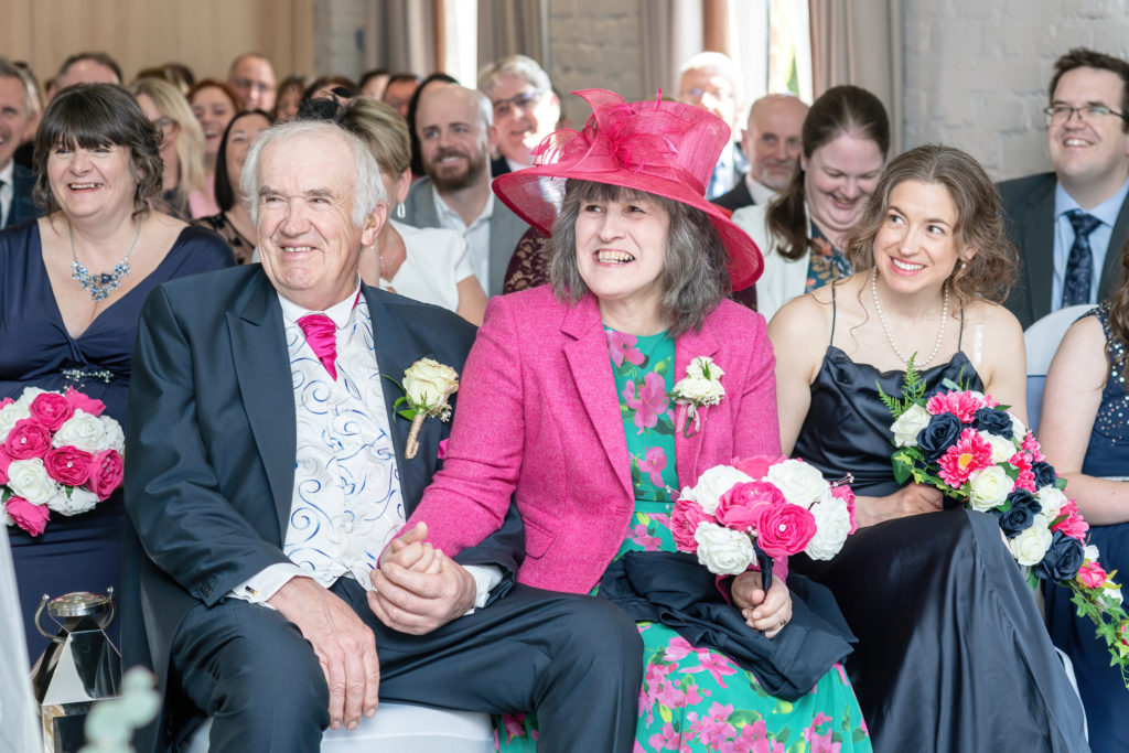 Natural candid moments of guests smiling and chatting during a relaxed spring wedding