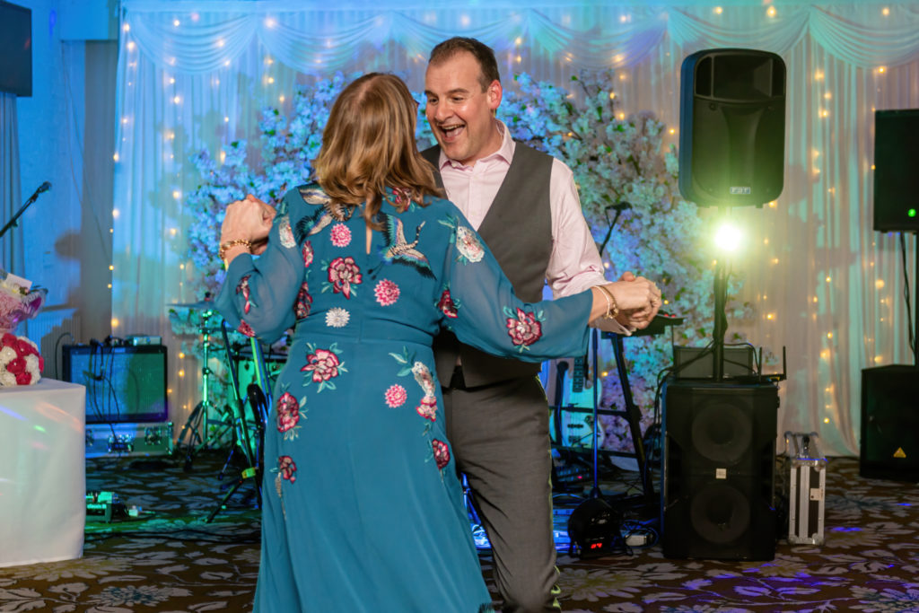 wedding guests dancing at Charlecote Pheasant Hotel - natural and fun wedding photography