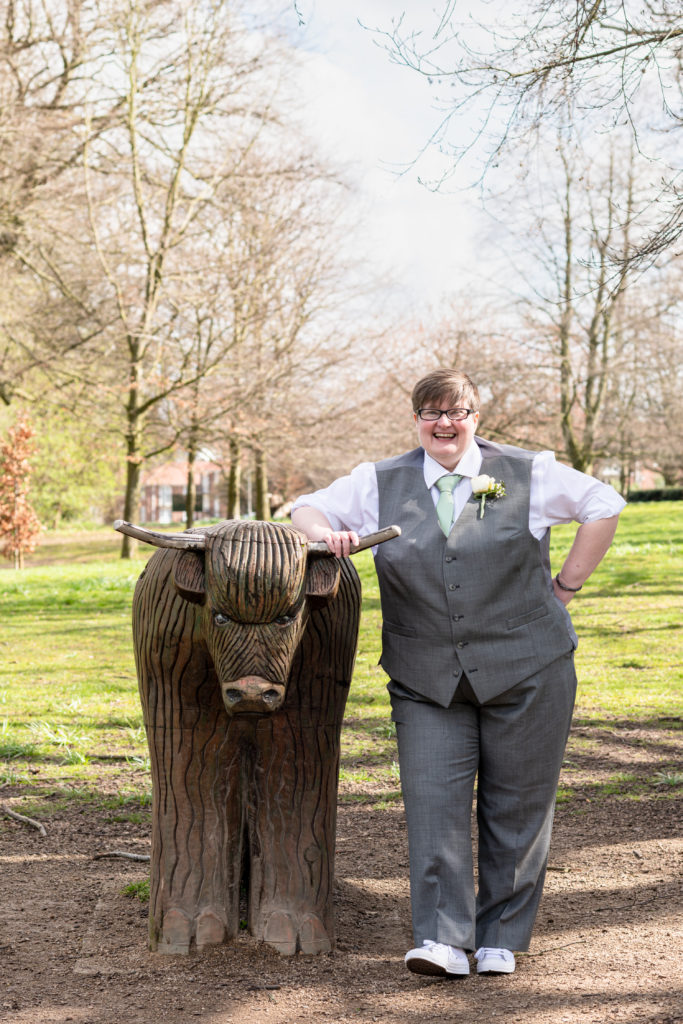Bride Jane smiling and posing with the bull statue at Bantock House
