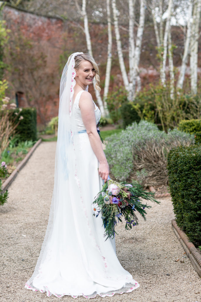 Bridgerton inspired wedding shoot with model in regency-style dress at the Walled Garden Beeston Fields