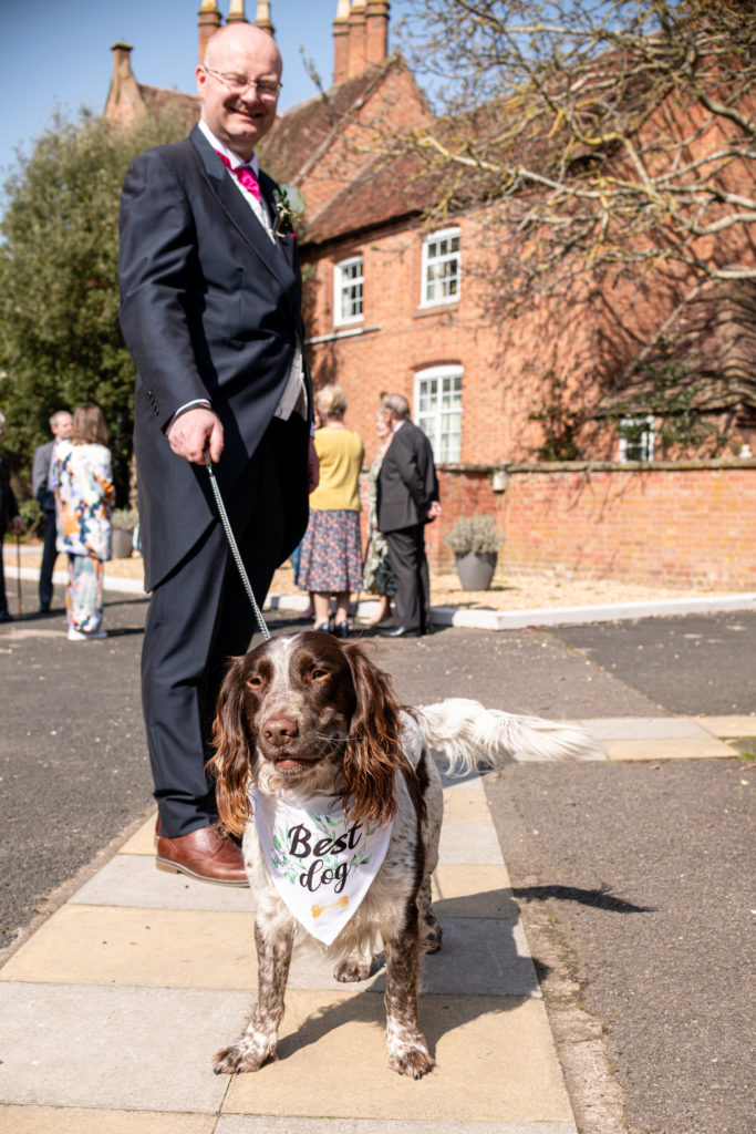 Bride and groom with their three dogs wearing bandanas at Charlecote Pheasant Hotel