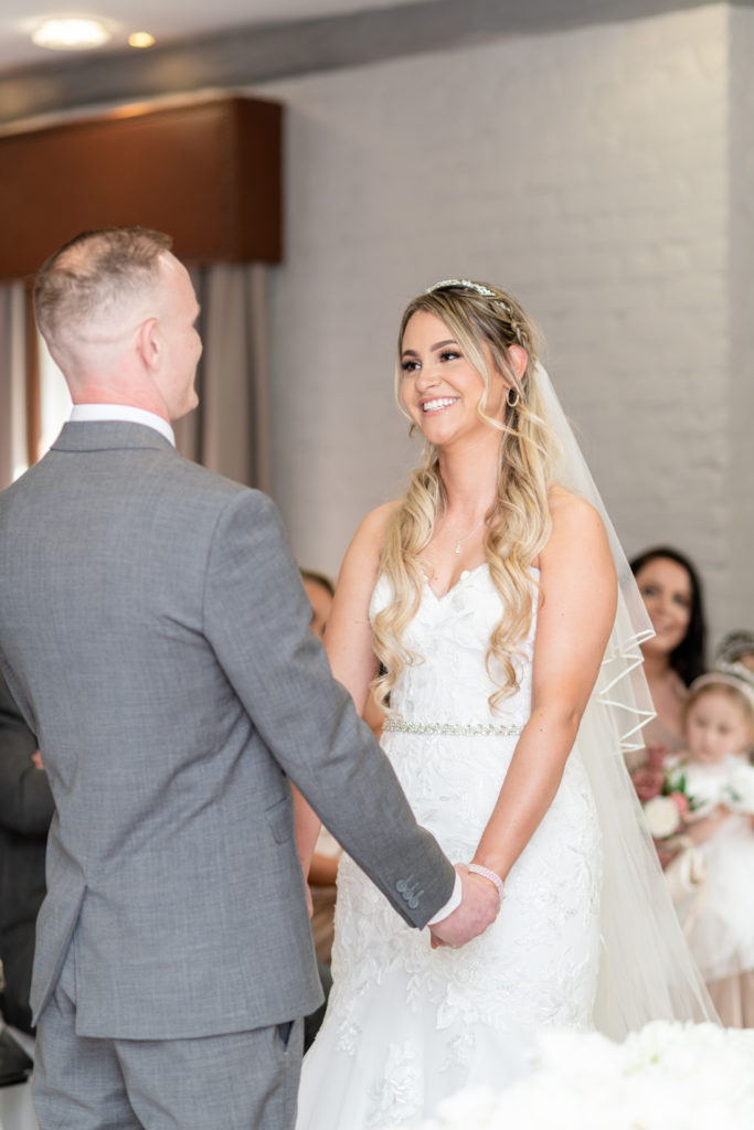 Bride Jady smiling during her wedding vows at Charlecote Pheasant Hotel