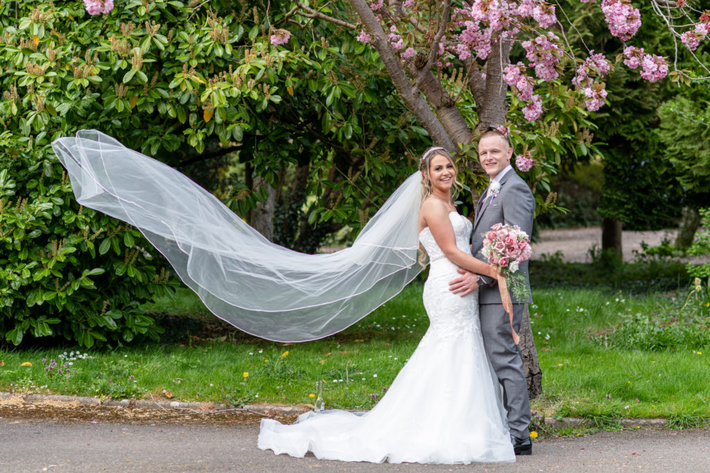 Jady and Perry holding hands and laughing during our spring wedding portraits