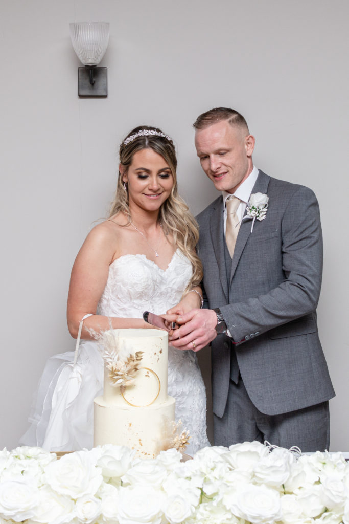 Jady and Perry cutting their wedding cake during evening reception