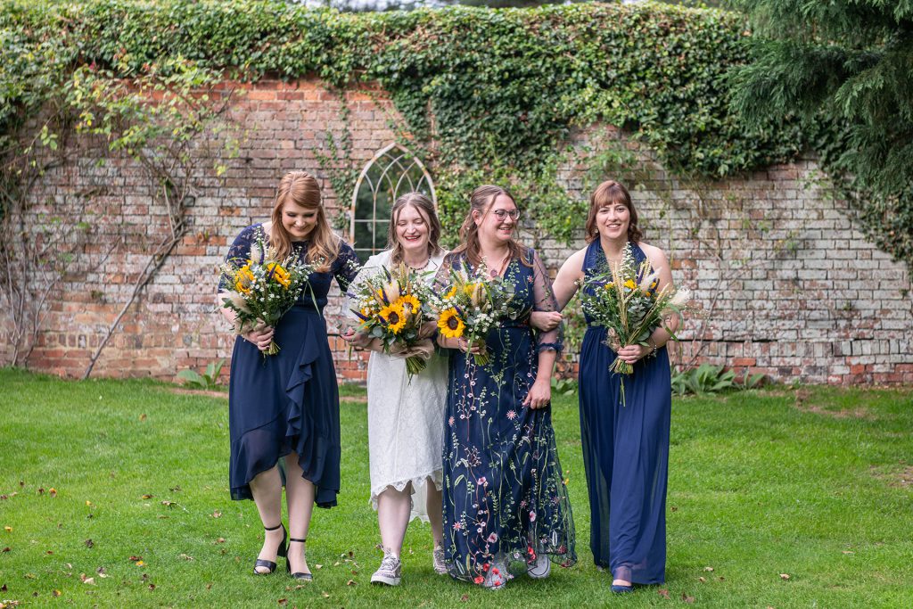Candid wedding photography of a bride and her bridesmaids laughing during relaxed celebration