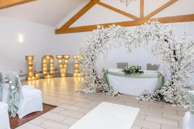 Elegant winter wedding ceremony setup with white florals and greenery at Draycote Hotel for Leah and Ryan’s celebratio