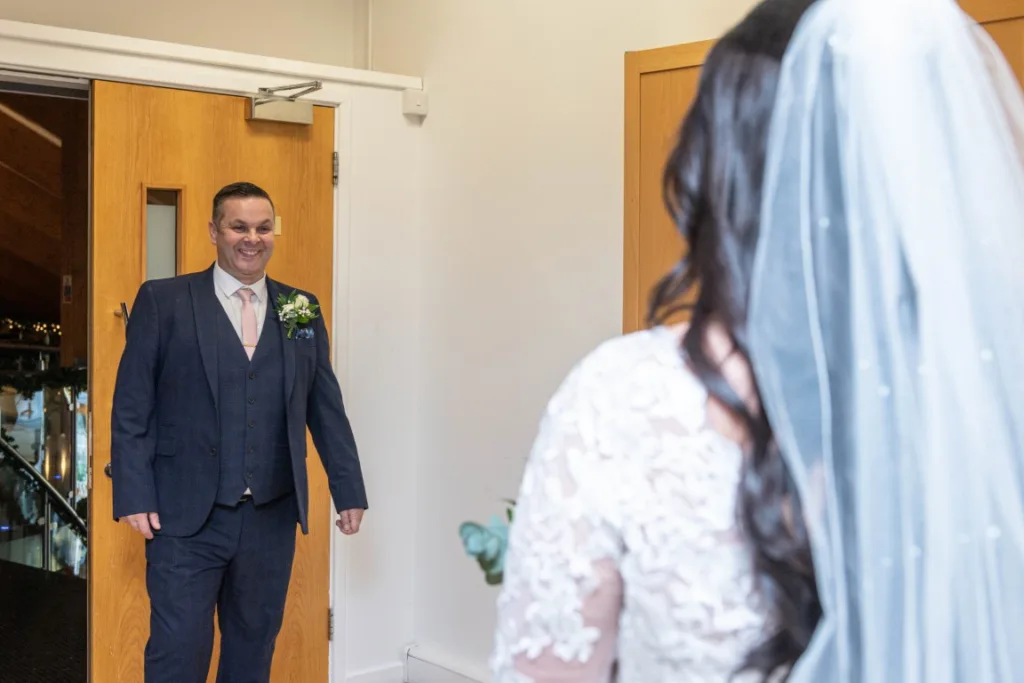 Heartfelt first look between Leah and a loved one before the ceremony at Draycote Hotel – a special winter wedding moment