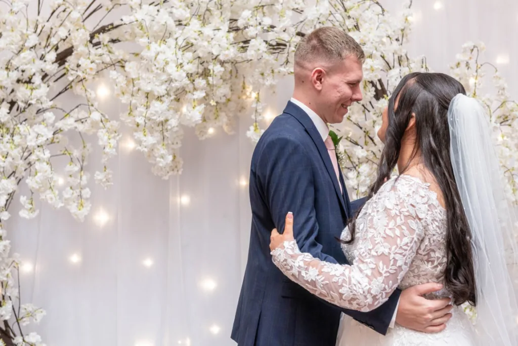 Leah and Ryan sharing their first dance surrounded by friends and family at their winter wedding at Draycote Hotel.