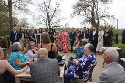 Candid behind-the-scenes moment of LB Photography capturing a wedding