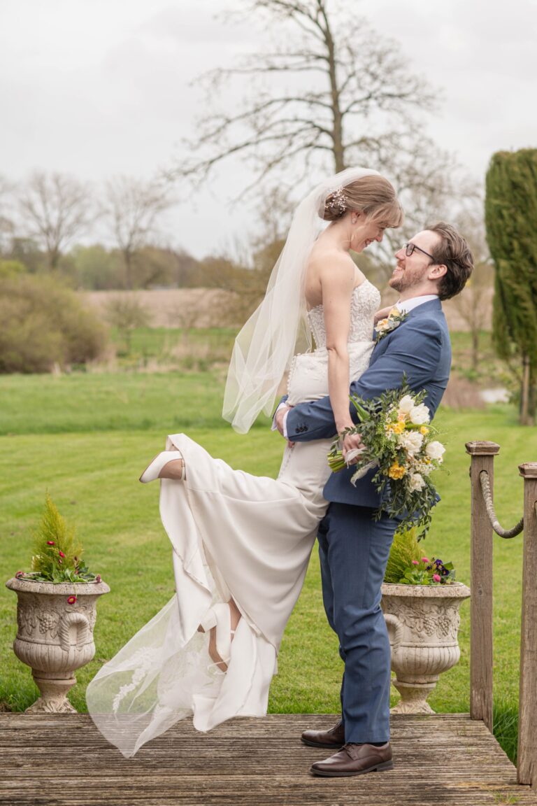 ​Bride twirling in her dress with groom smiling, capturing laid-back and fun wedding moments.