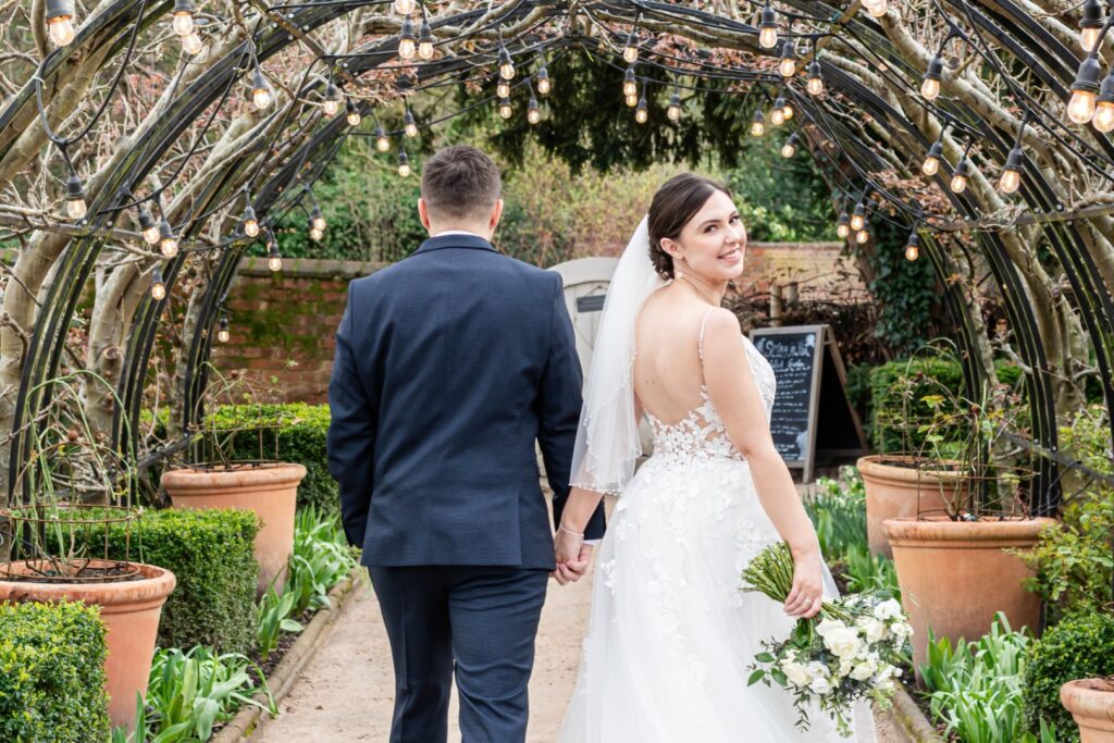 Couple walking hand-in-hand during golden hour as part of their Stress-Free Wedding Timeline