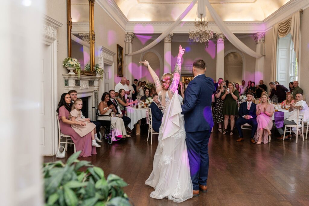 Wedding Photography Portfolio – joyful first dance moment with cheering guests