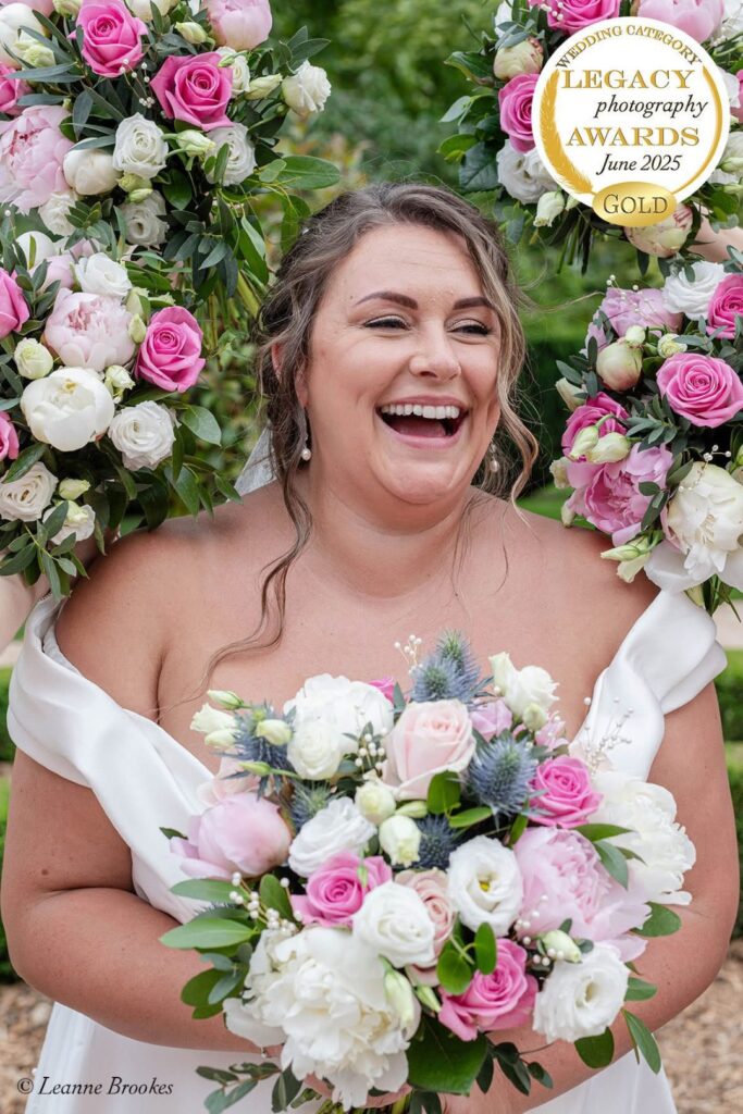 Wedding Photography Portfolio – natural moment of bride laughing holding bouquet