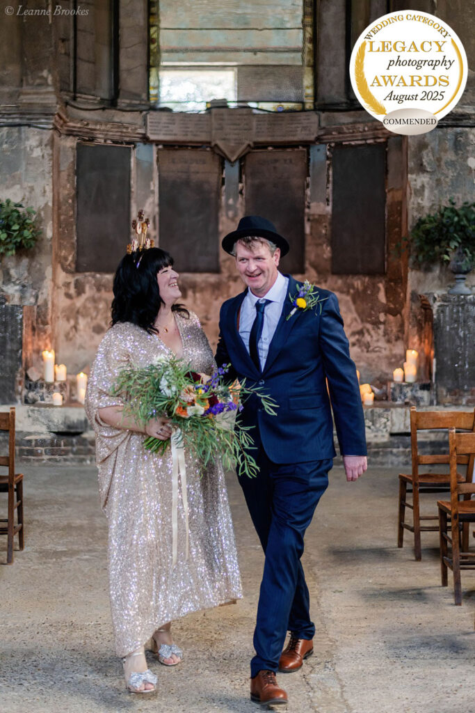 Wedding Photography Portfolio – joyful couple walking together in rustic candlelit venue