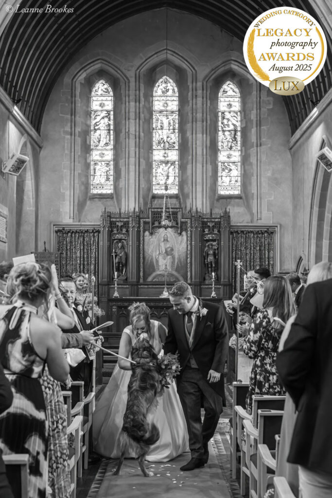 Wedding Photography Portfolio – black and white church ceremony exit with bride, groom and their dog