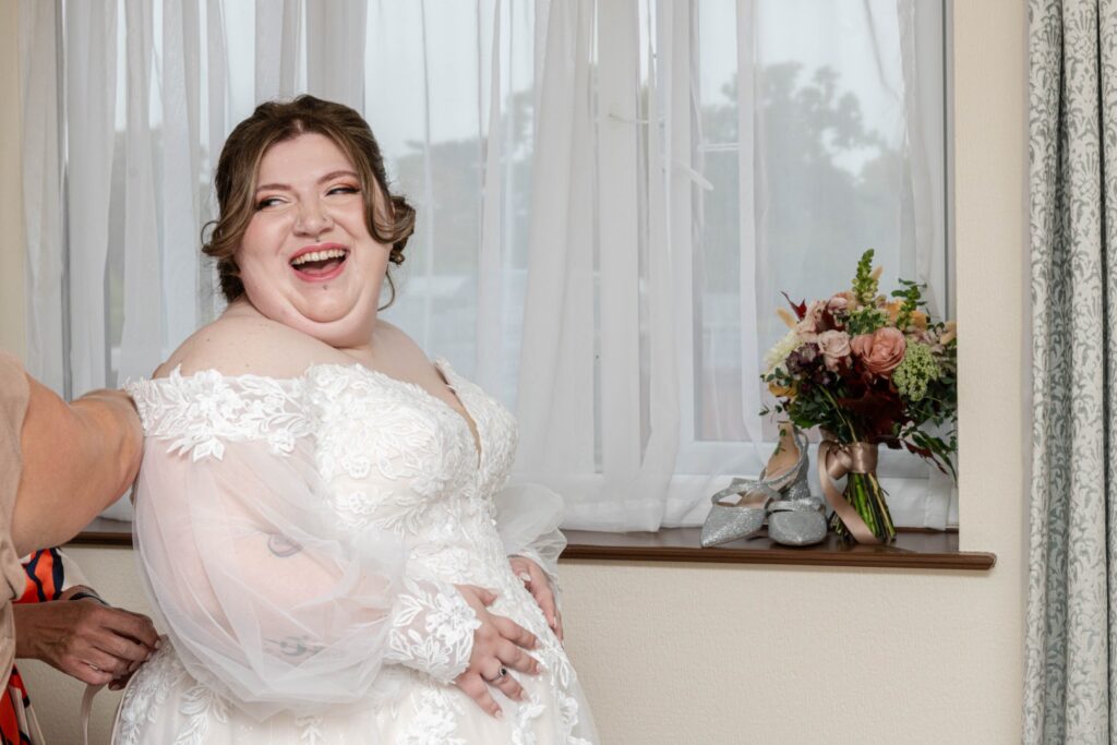 natural wedding photography showing real laughter during bridal prep