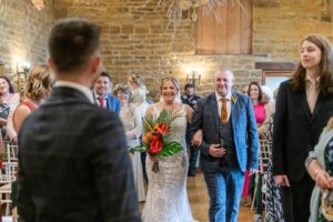 Bride walking down the aisle captured by a natural wedding photographer in Nuneaton