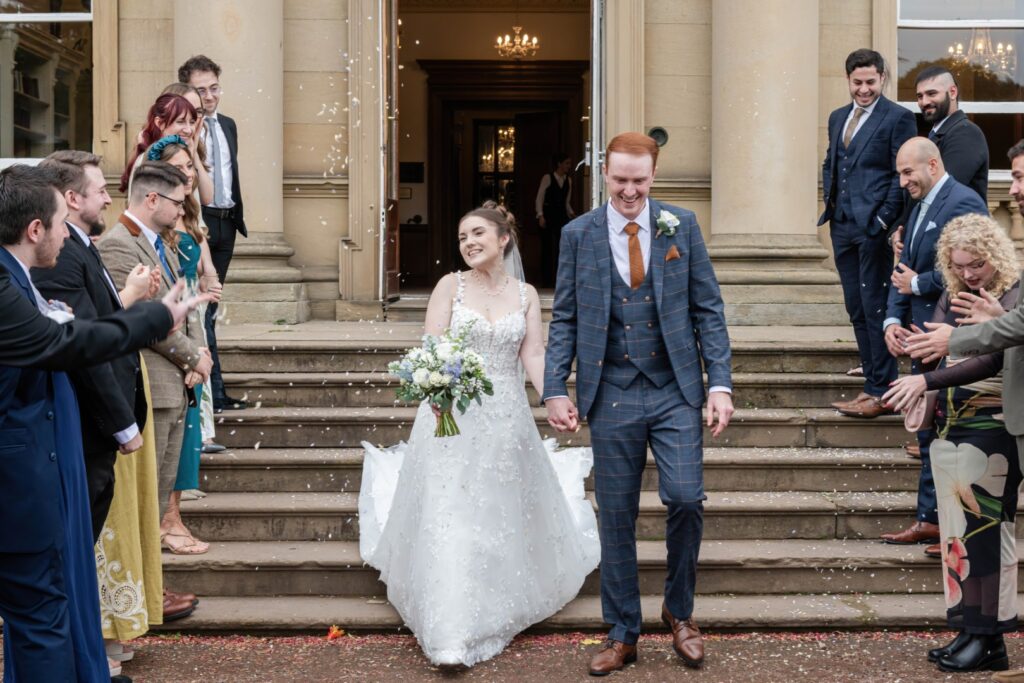 Bride and groom laughing during confetti moment