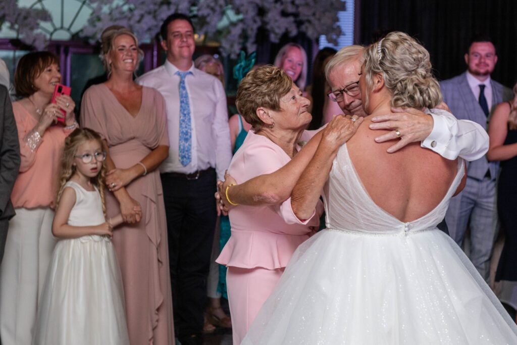 Candid dance floor photo of bride and guest – capturing the joy and magic of candid wedding photography