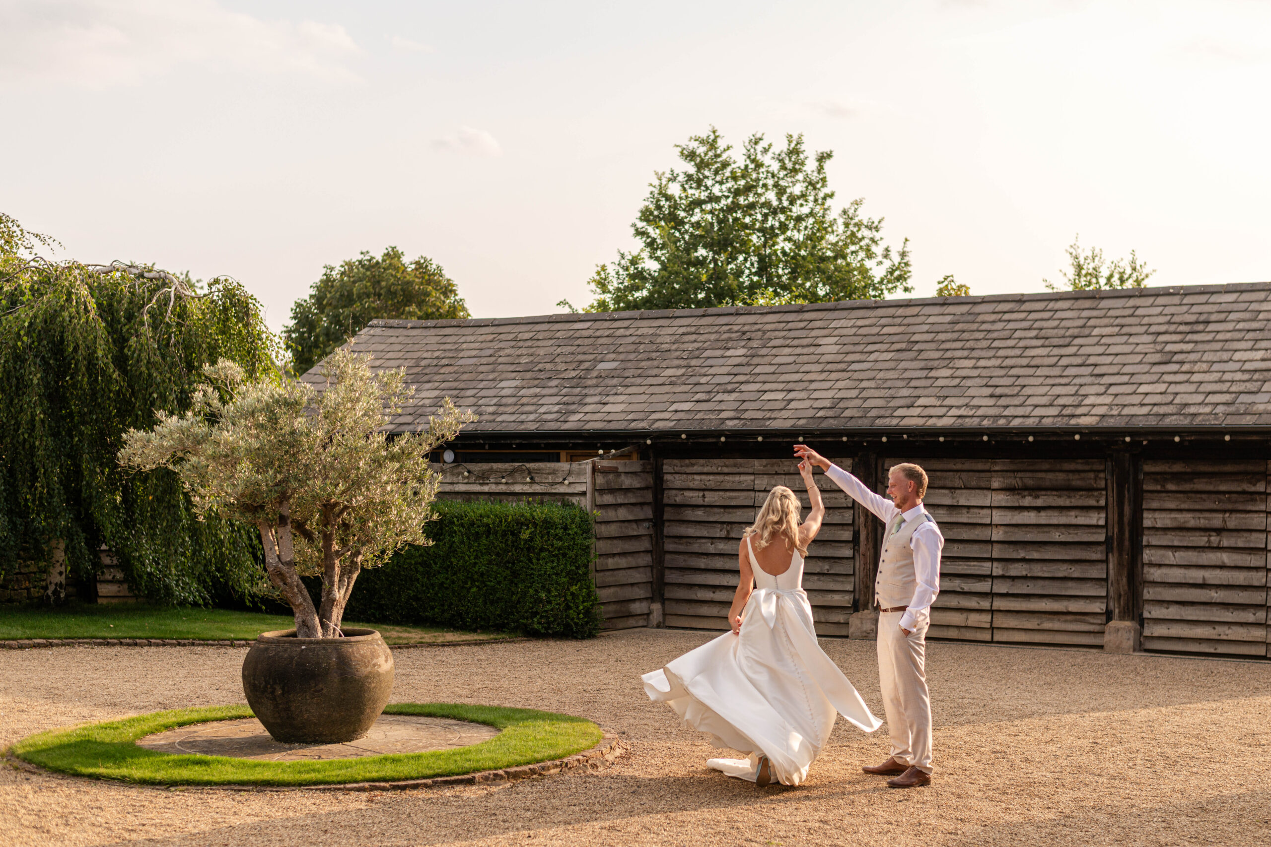 Bride and groom dancing at their barn wedding in Warwickshire